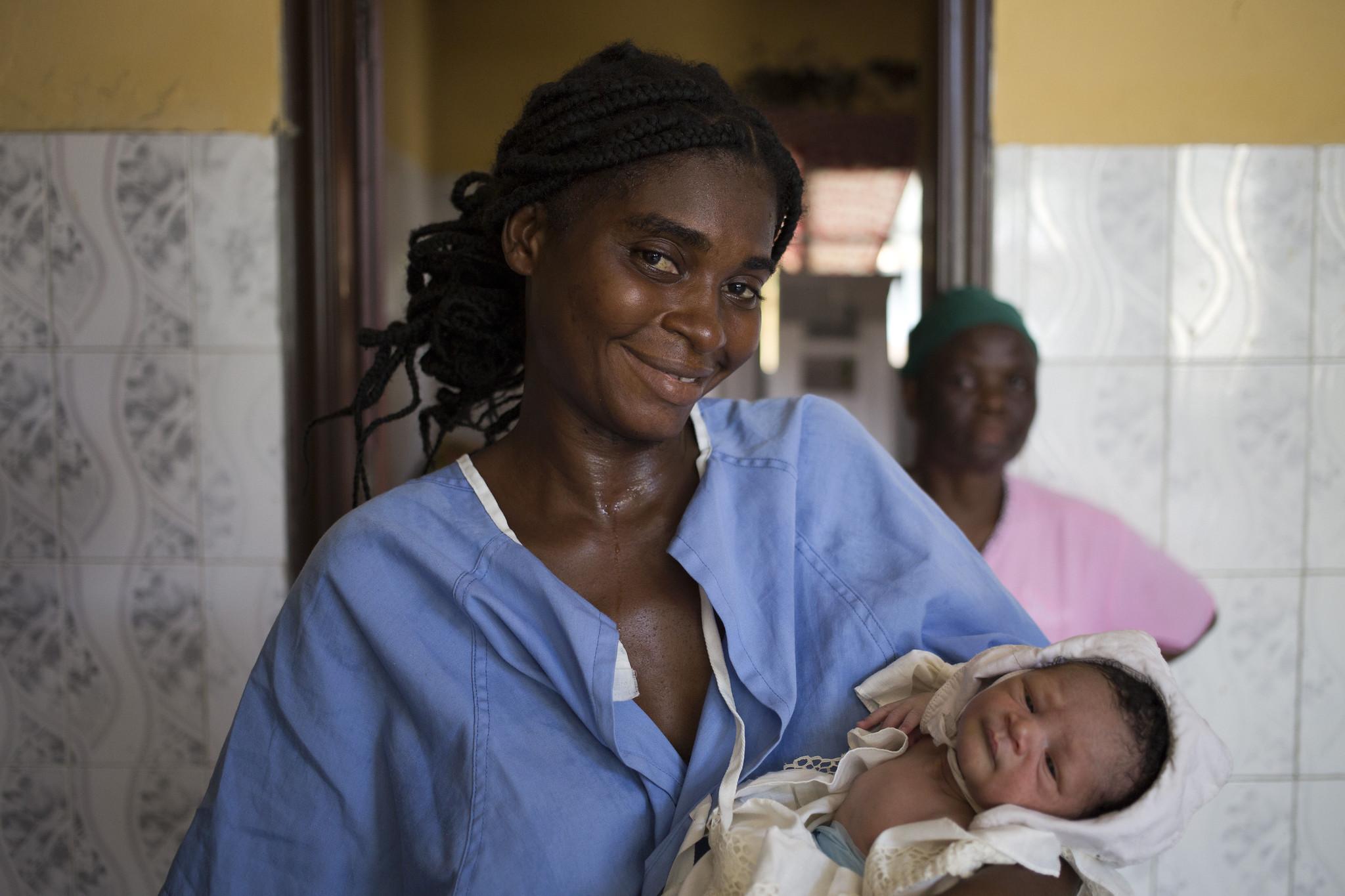 Female doctor holding new born baby